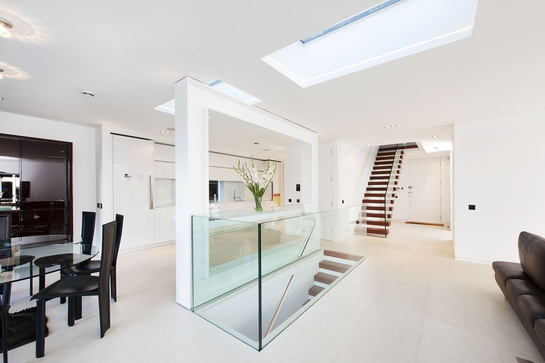 Bright dining are and stair case with two skylights