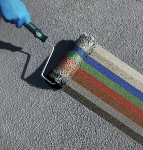 Paintbrush demonstrating the variety of colours available for water-based bitumen