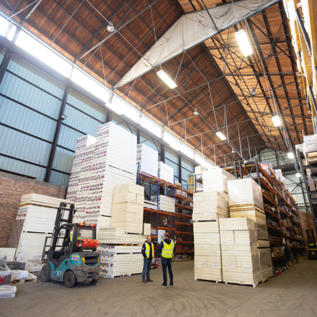 A large warehouse stacked with roofing supplies