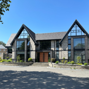 A large double fronted house with glass windows