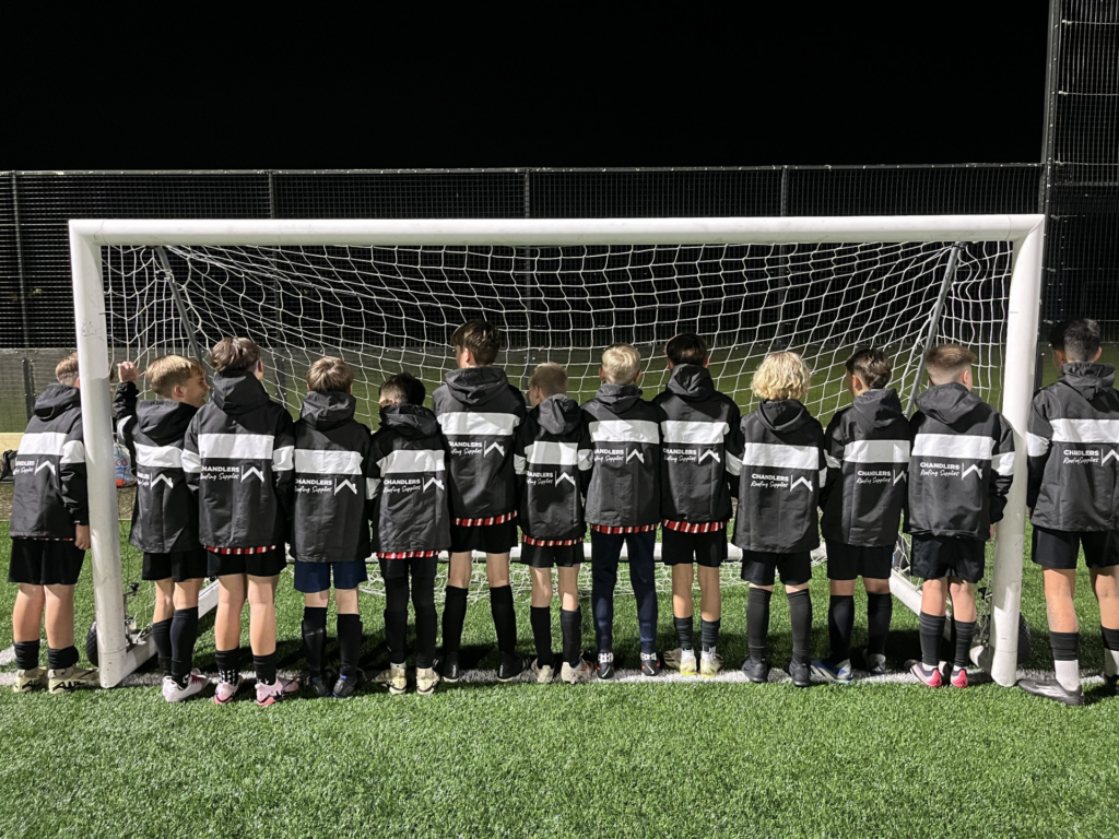 Team of boys smiling in their football kick