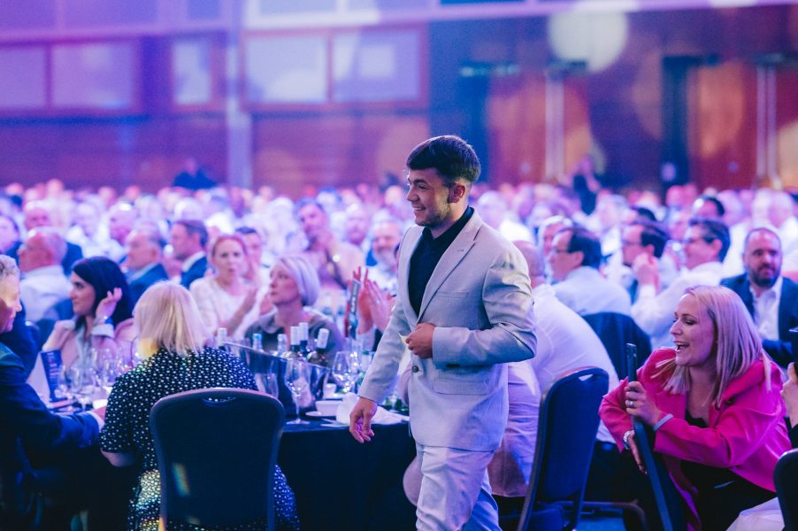 Young Roofer of the Year, Frankie Storrie walking to the stage to collect his award