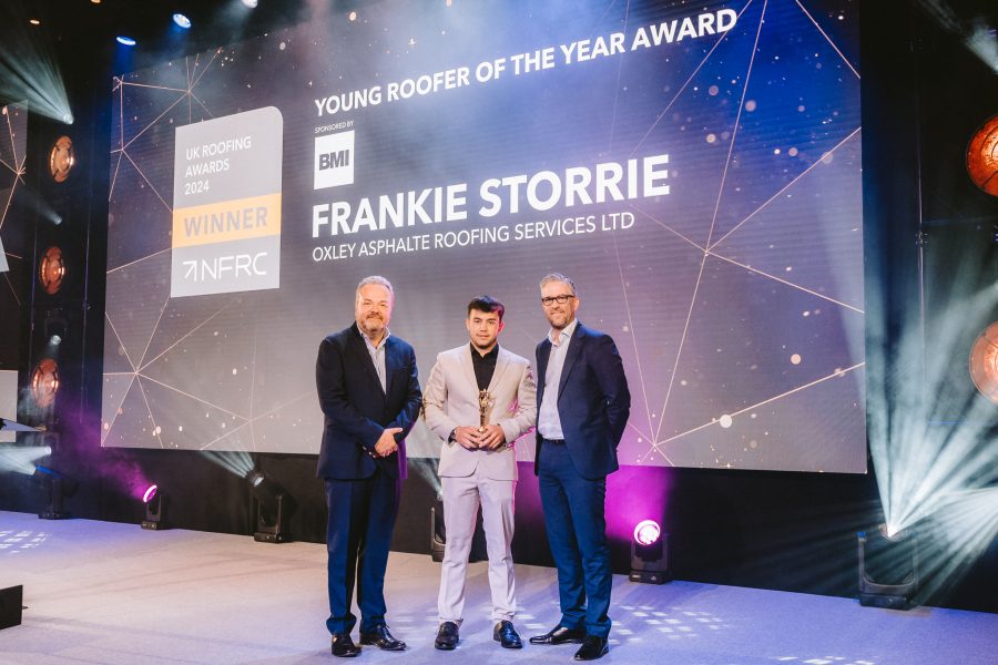 Young Roofer of the Year, Frankie Storrie on the stage with his award